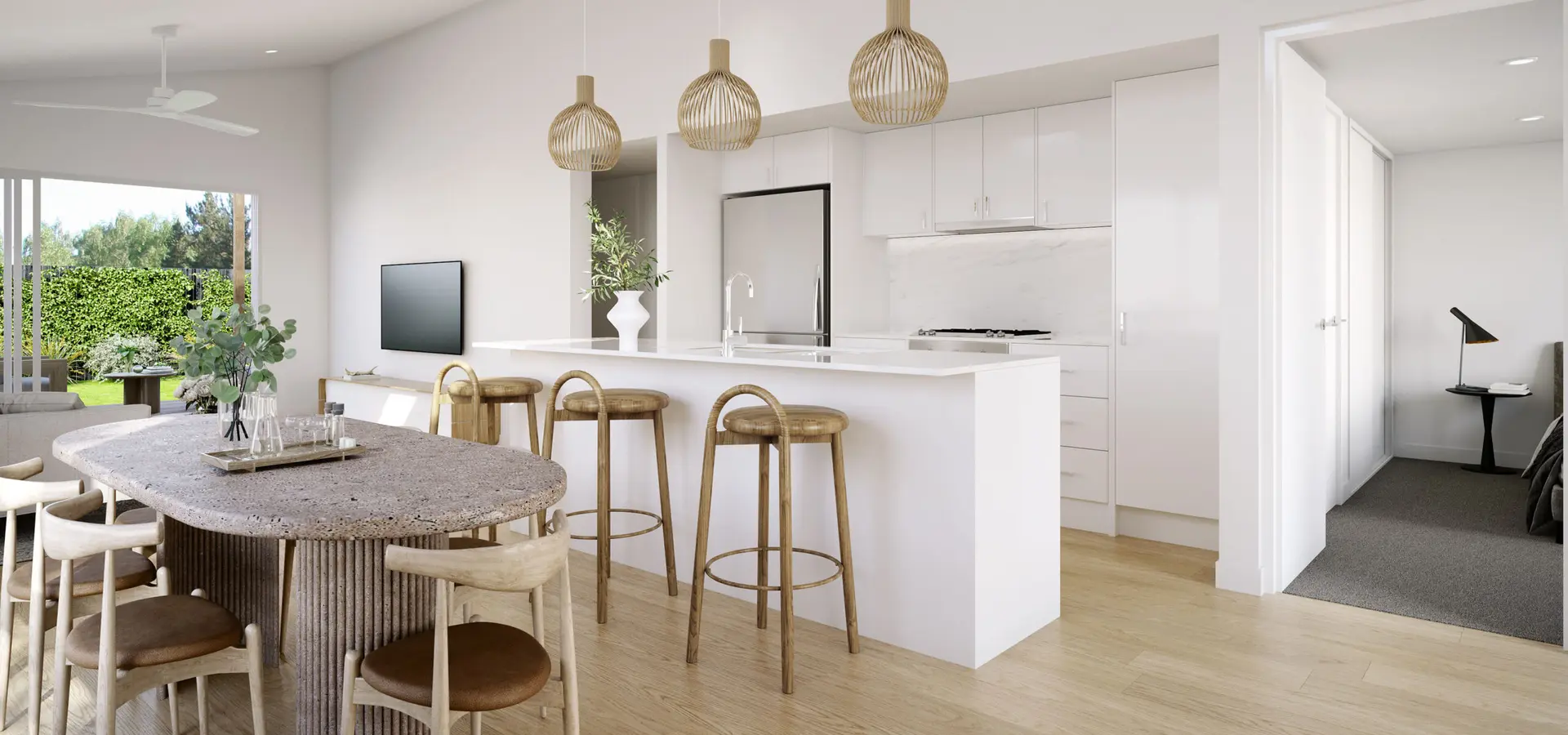 Modern lifestyle village kitchen with minimalist design: white island/stools, stone dining table, pendant lighting, large windows showing green outdoors.